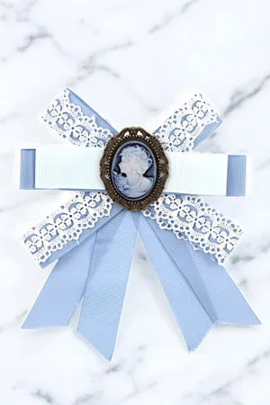 ANTIQUE FRAMED BLUE BOW BROOCH