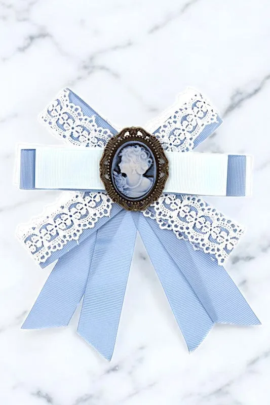 ANTIQUE FRAMED BLUE BOW BROOCH