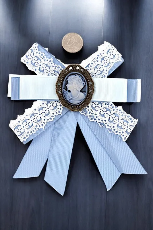 ANTIQUE FRAMED BLUE BOW BROOCH