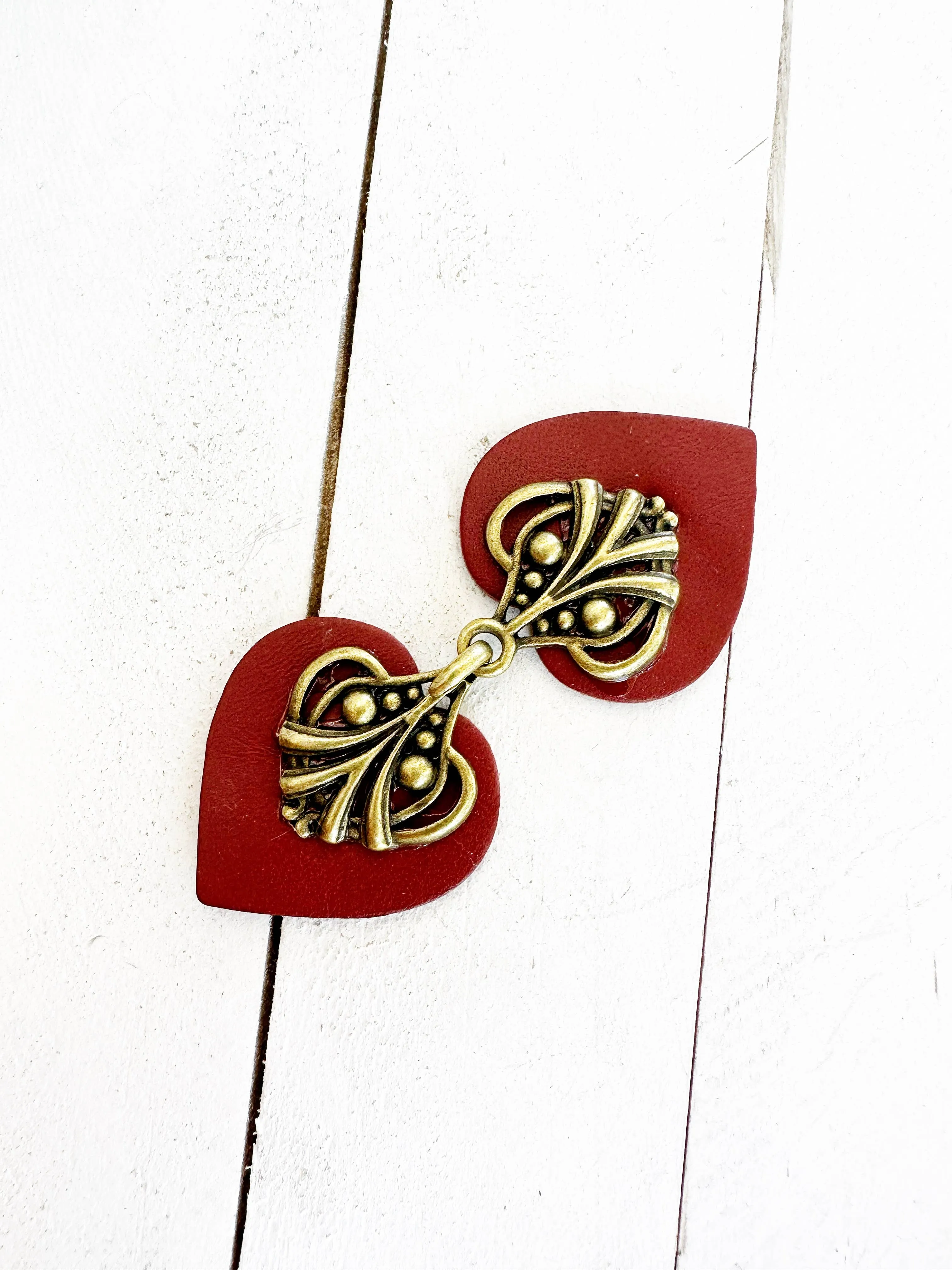 Dress Clip -Myriad Bronze on Dark Red Leather
