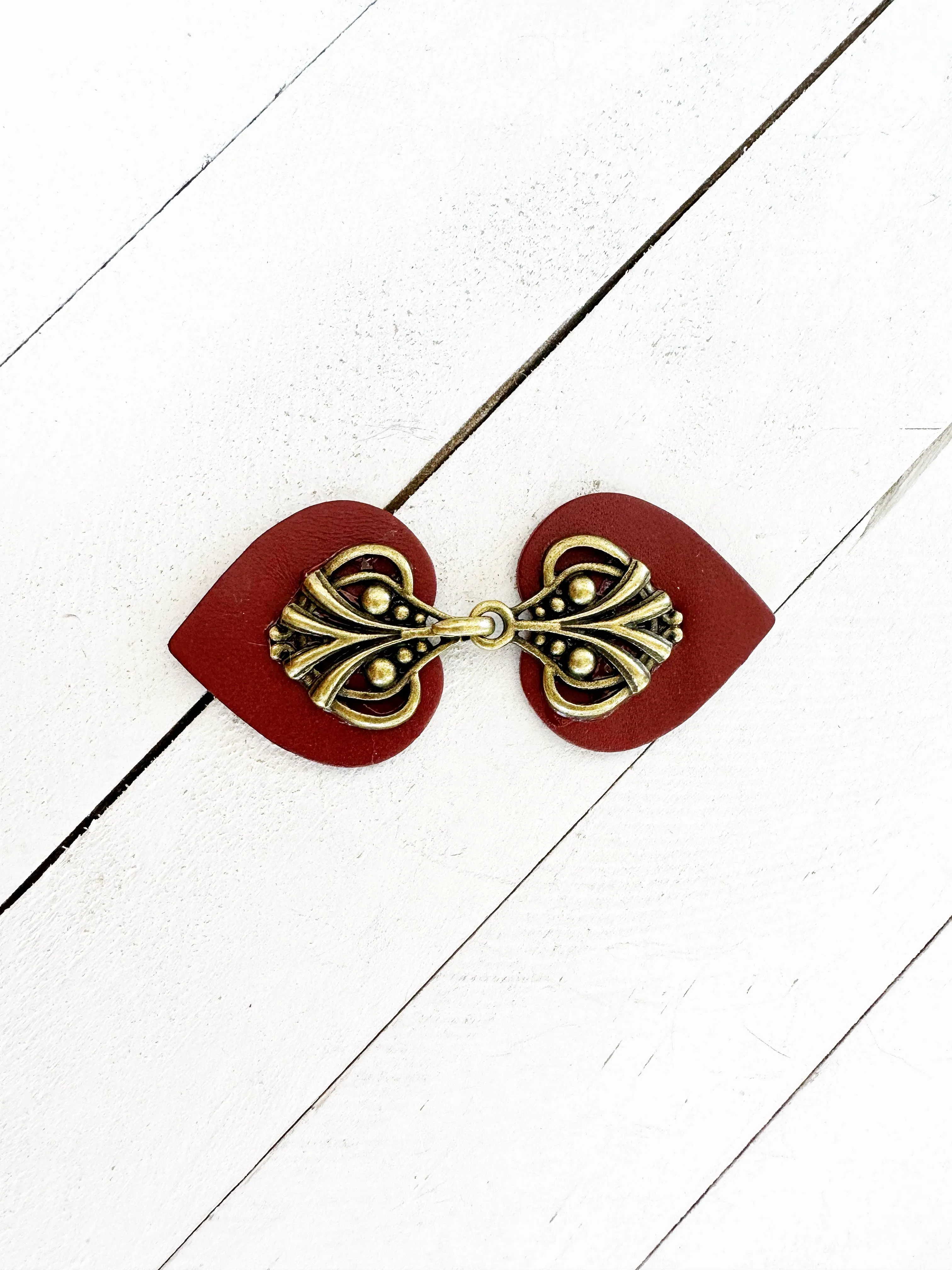 Dress Clip -Myriad Bronze on Dark Red Leather